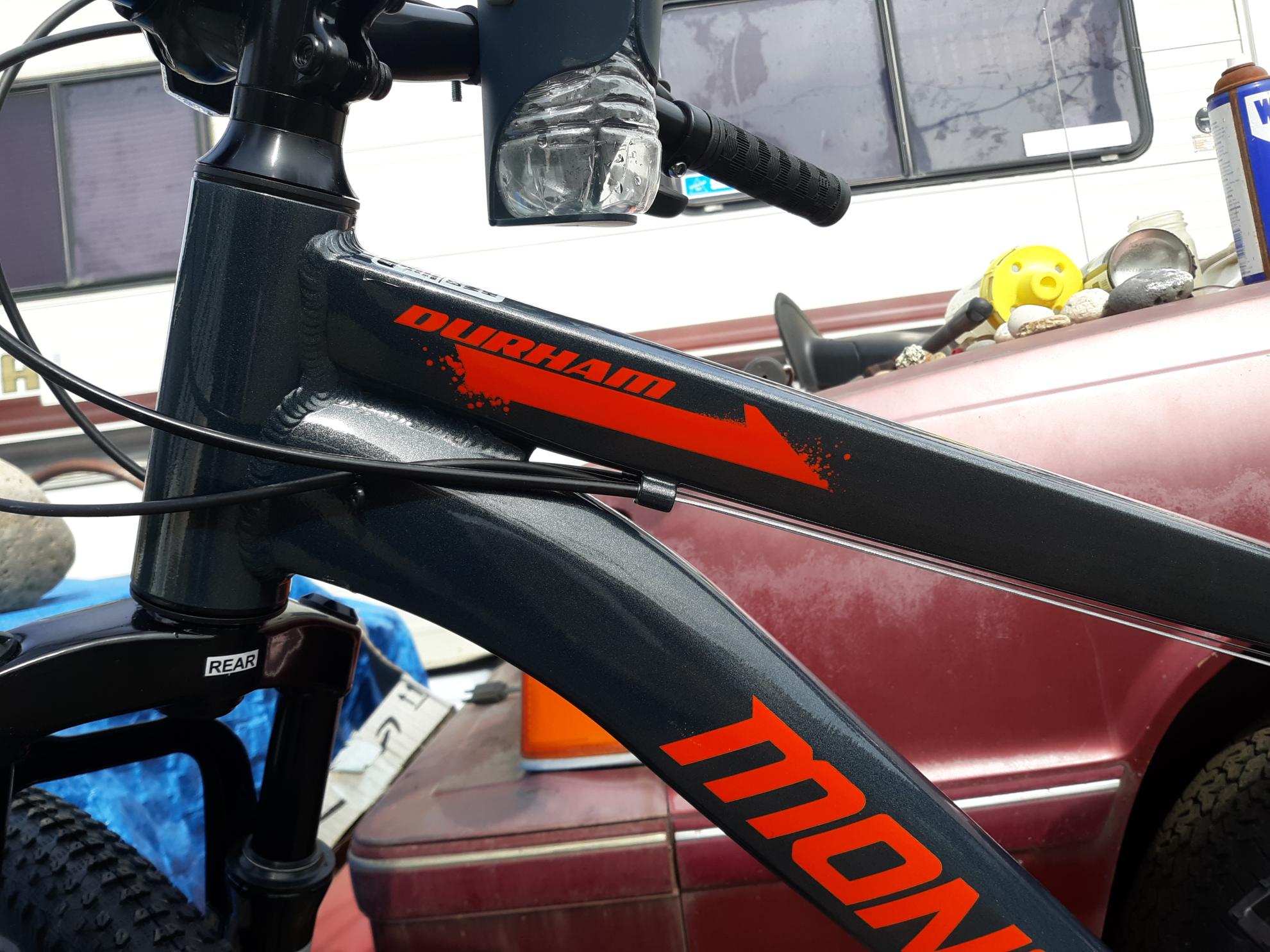 Mongoose Durham mountain bike 29-inch, 21 speed Silver, gray or bare metal and Orange